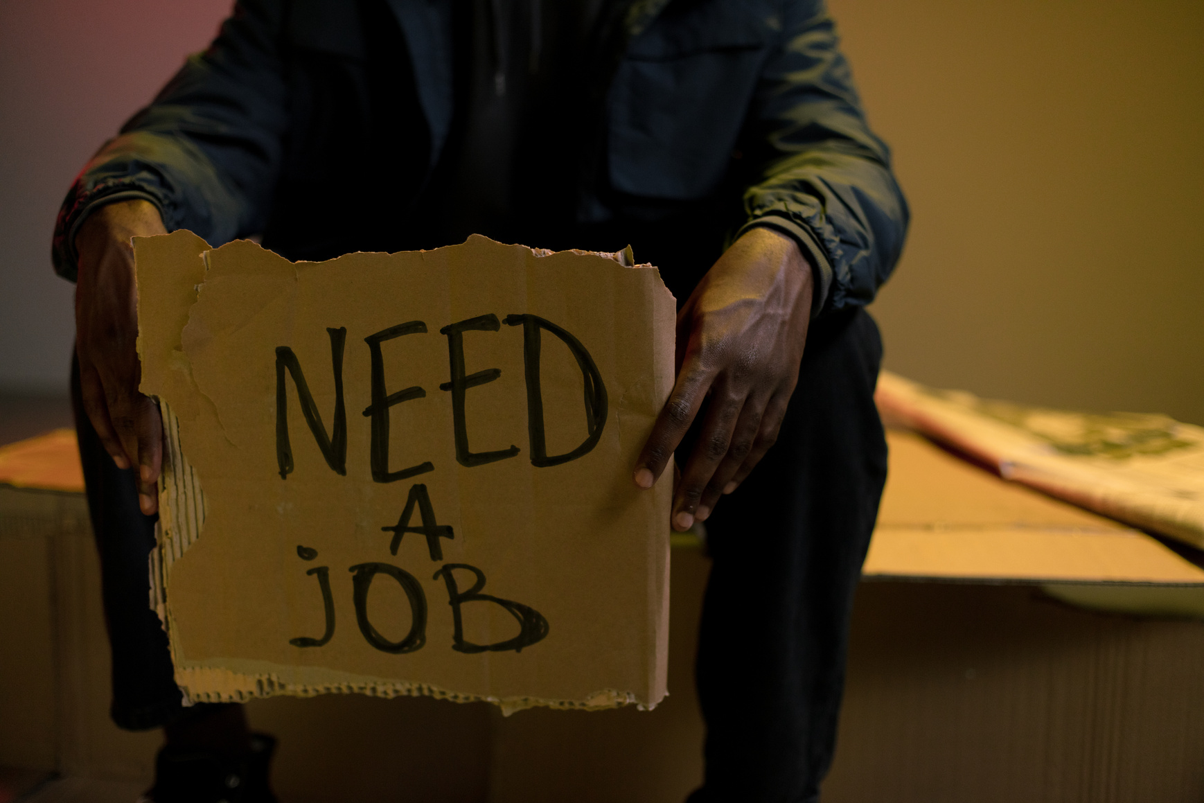 Homeless man holding cardboard in hands